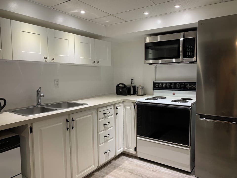 Kitchen with fridge, stove, microwave and dishwasher, plus essentials