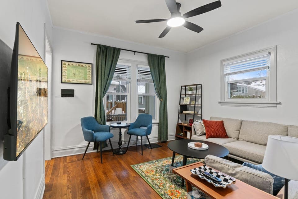 Living room includes comfy sectional seating for 4, 2 window seats, and smart TV