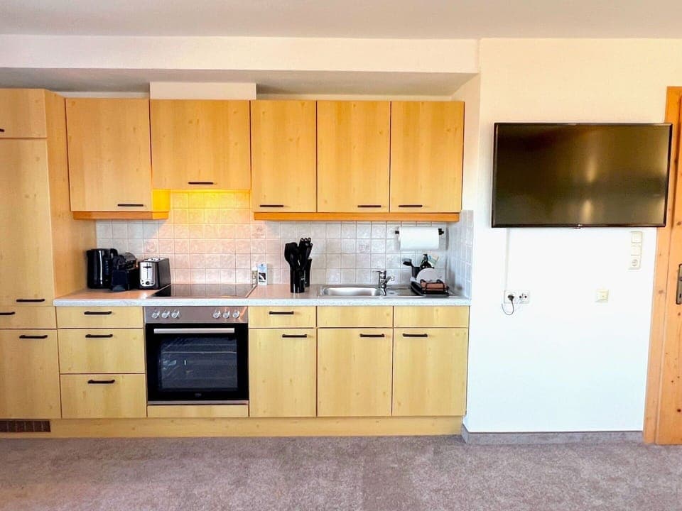 Furniture, Kitchen, Wood, Cabinetry, Flooring, Interior Design, Countertop, Kitchen Appliance, Floor, Major Appliance