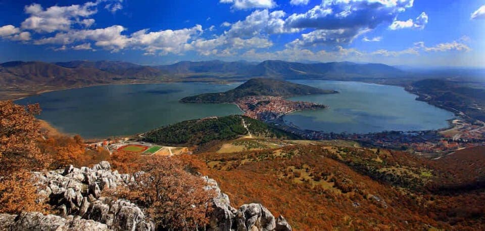 Stunning panoramic view of Lake Kastoria, surrounded by mountains and the charming lakeside town.