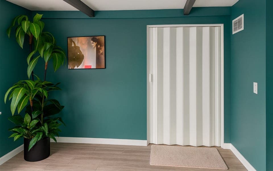 Private entrance corridor to The Gold Room at Garden of Manors, with modern teal walls and greenery welcoming you into the space.