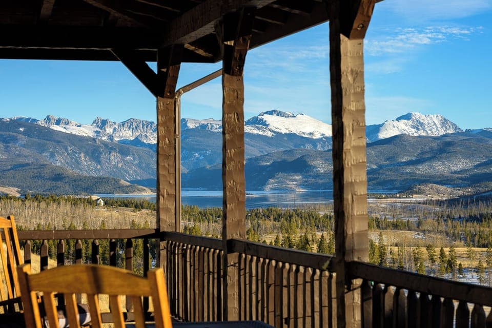 Breathtaking mountain and lake panorama from your private covered deck, where morning coffee becomes a spectacular ritual.