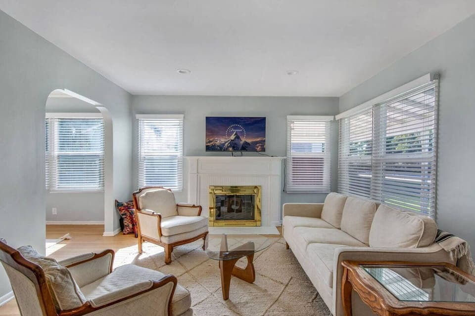 Comfortable living room with plush seating, fireplace, and Smart TV for streaming.