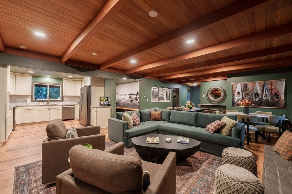 A wide-open gathering space with a huge sectional, cozy seating, and the fully equipped kitchen just steps away—perfect for groups to cook, relax, and spread out together.