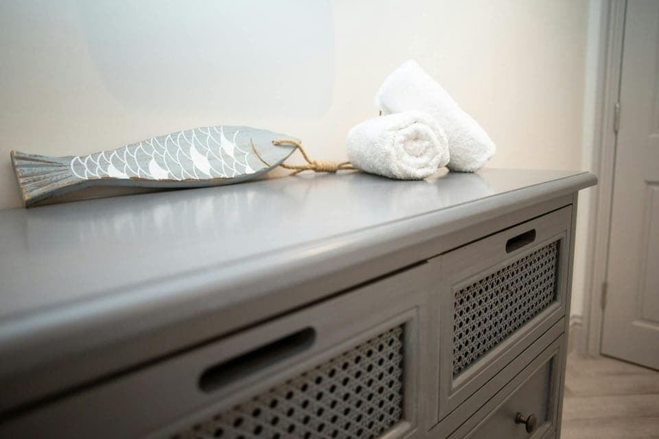 Chest of drawers with fish ornament and towels