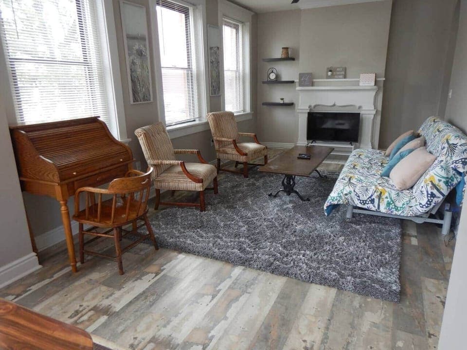 This is the living room from the sun room.  Kitchen is to the right.  We have added a roll top desk so you can work/play and then roll the top down.  The futon is on the right.  Note the thickness of the cushion.