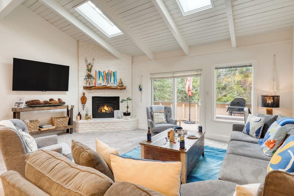 Living room featuring a fireplace, TV, and comfortable seating. (Ski Way)
