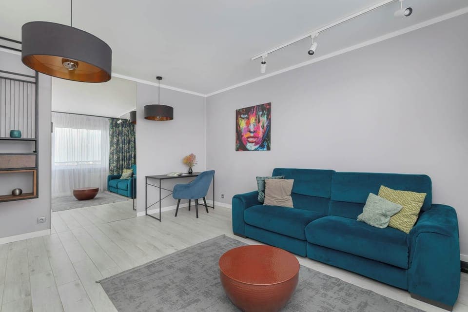 Relax in the stylish living room with a comfortable sofa and modern decor.