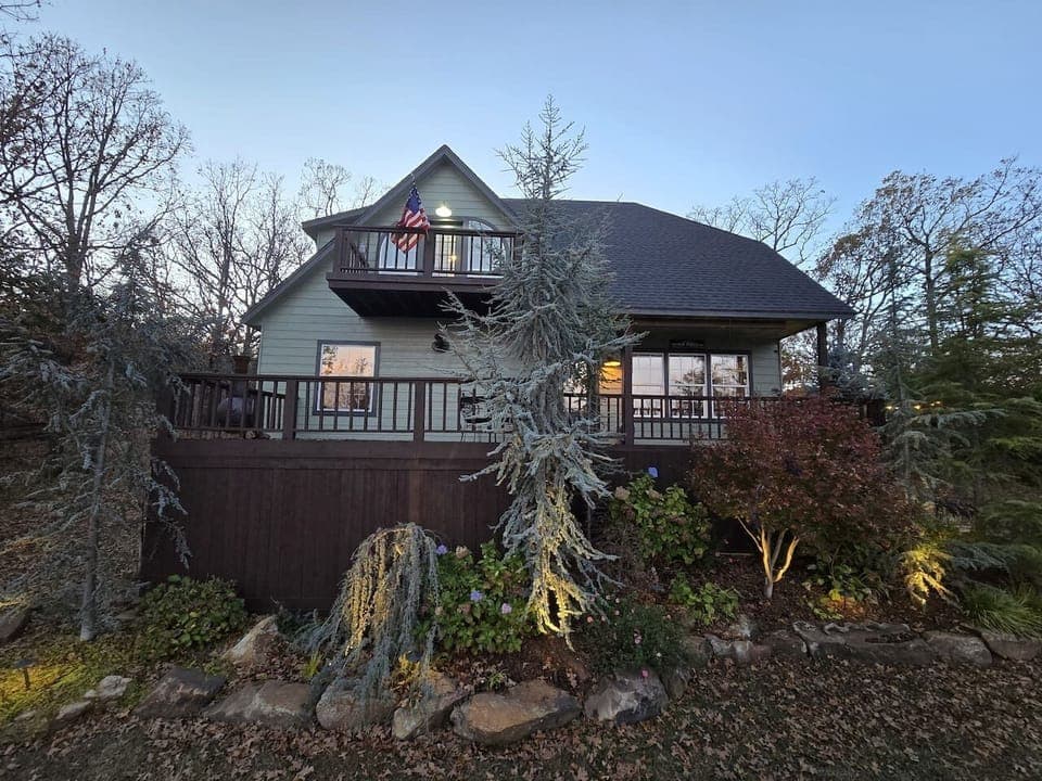 The home lights the landscaping beautifully as the sun goes down