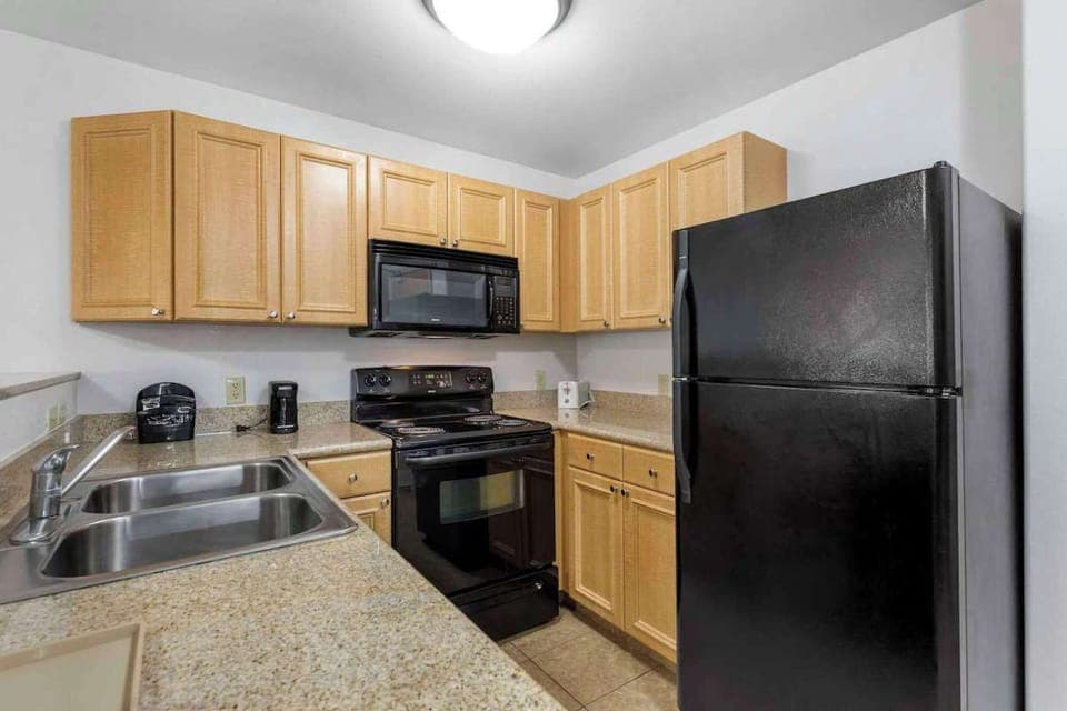 Full kitchen with stove, microwave, fridge, and plenty of counter space