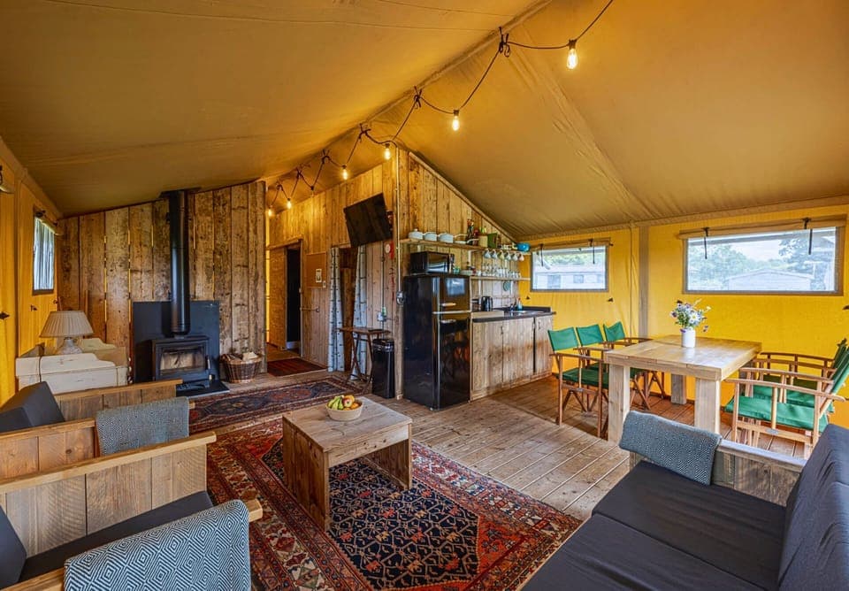 Spacious open-plan kitchen, dining and sitting area with a log burner