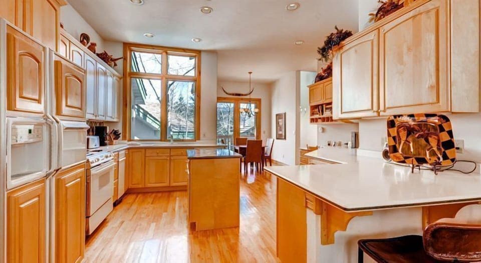 Spacious kitchen with sleek countertops, warm wood cabinetry, and modern appliances ideal for preparing hearty mountain meals.