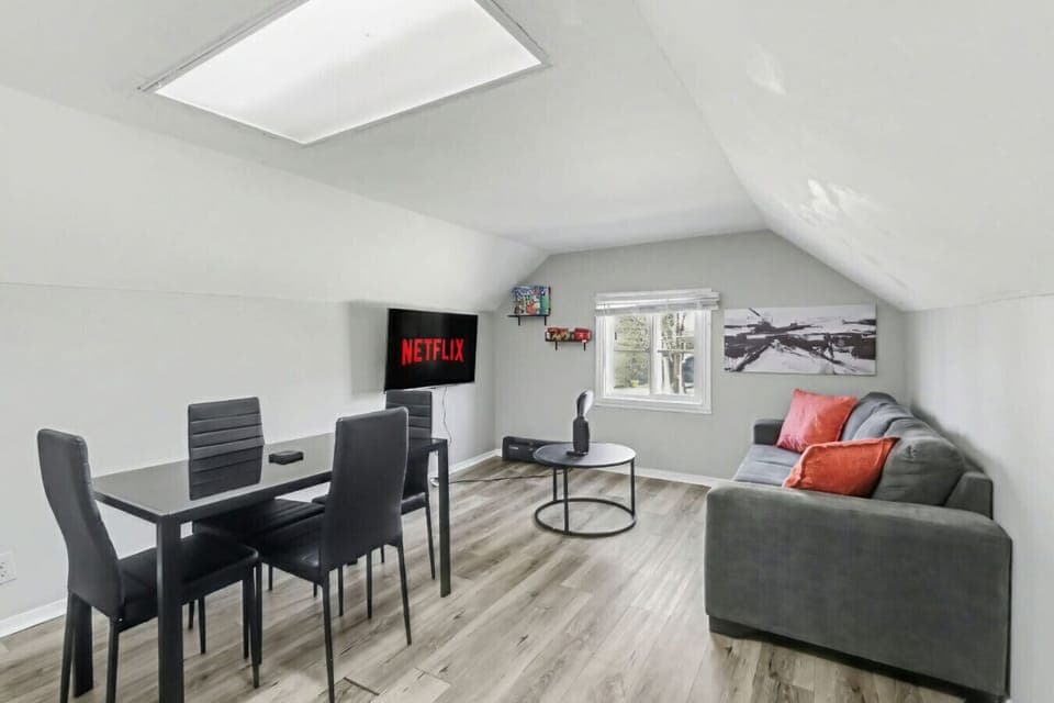 Retreat to this stylish attic hideaway. Whether you are catching a movie on the sofa or enjoying a meal at the sleek dining table, this bright and modern space offers the perfect cozy atmosphere for your next getaway.