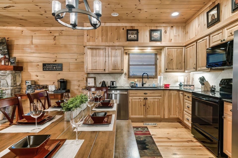 Fully equipped kitchen and dining area with rustic cabin charm.