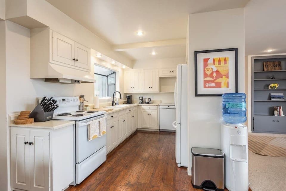 Warm, inviting kitchen with classic cabinetry and modern essentials—ideal for easy meals, morning coffee, and gathering with loved ones.
