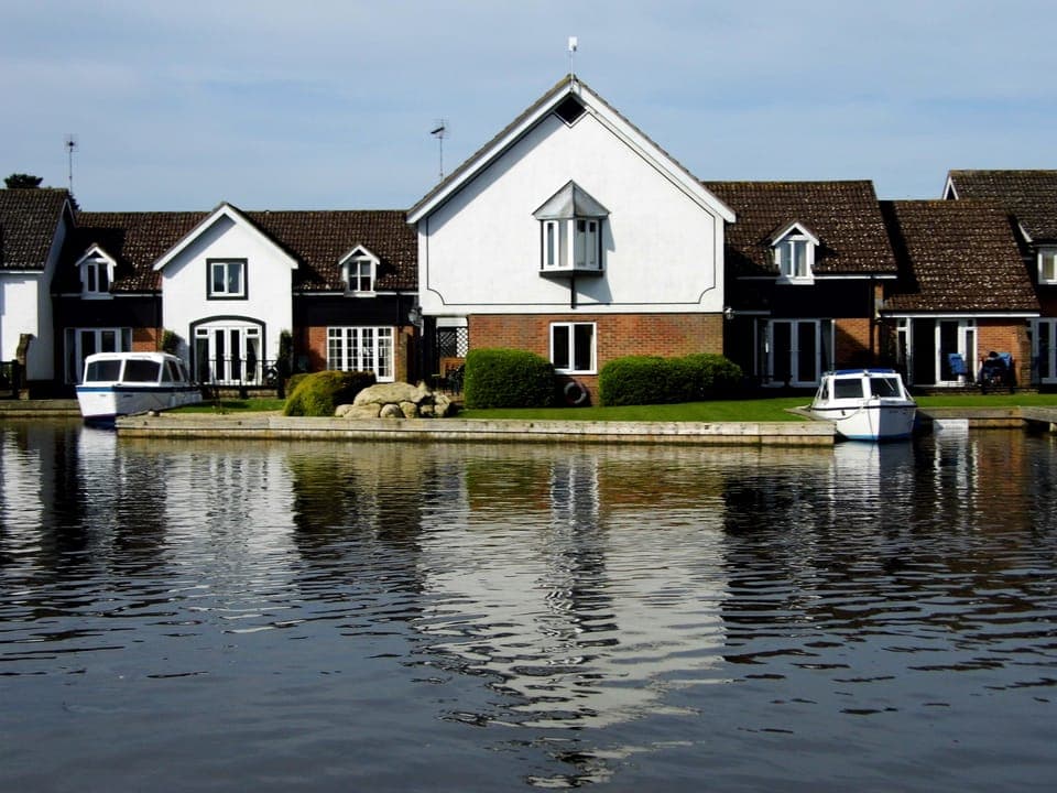 Wherry Cottage (centre) with views along and across River Bure, Wroxham.