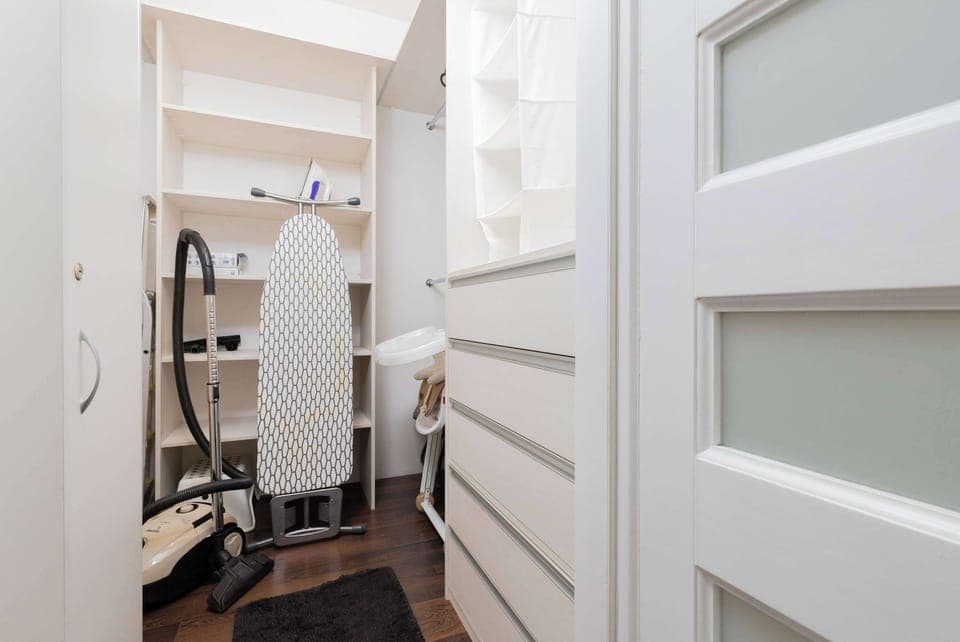 A dedicated wardrobe space with ample storage for luggage and clothing.