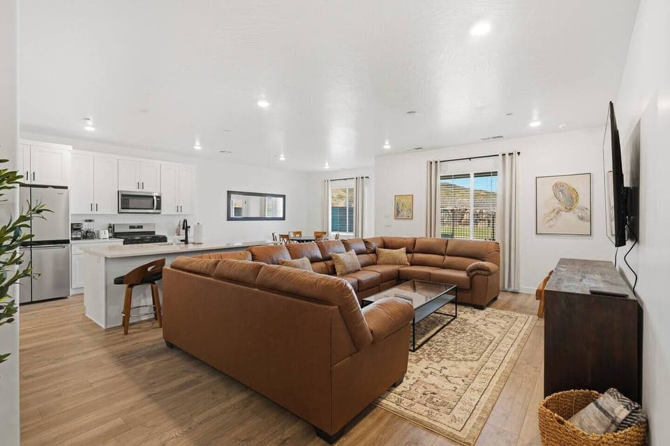 Spacious open concept living room with a comfortable sectional sofa and smart TV.