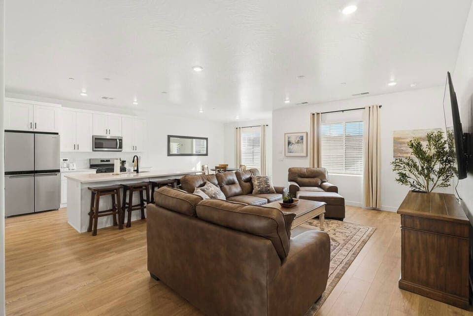 Bright open living area with comfortable seating and kitchen access.