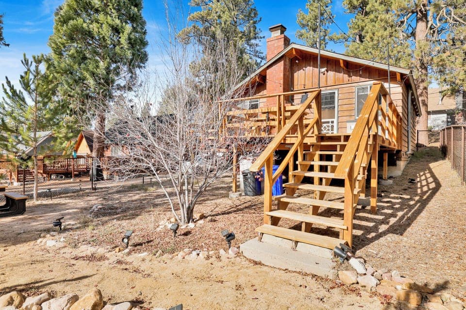Private outdoor backyard, surrounded by tall pines, perfect for relaxing under the trees after a day of adventure—enjoy peaceful forest views, fresh air, and a truly rejuvenating stay.