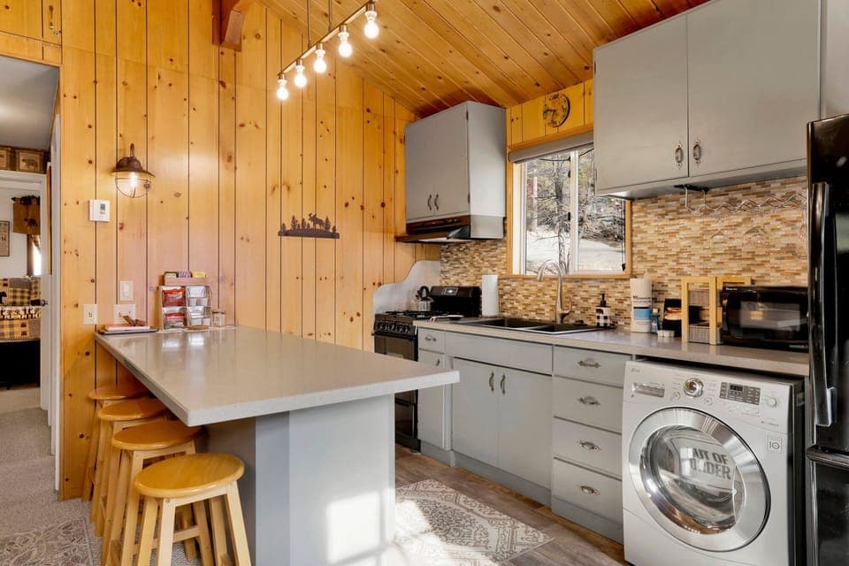 Fully equipped cabin kitchen with ample cabinetry, stove, fridge, microwave, and coffee maker—perfect for cooking meals, morning coffee, and feeling right at home on your stay.