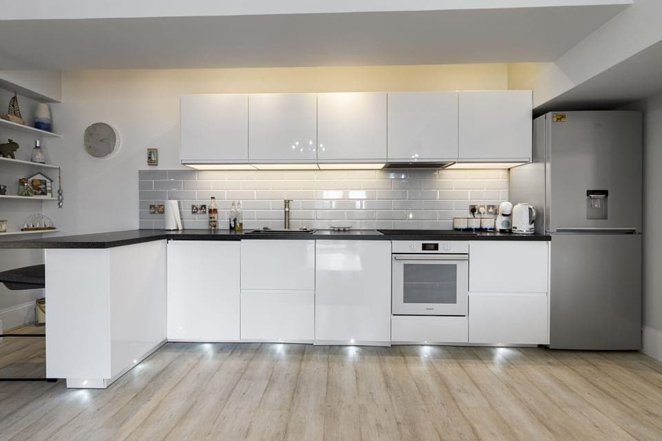 Modern white kitchen with oven, hob and plenty of workspace
