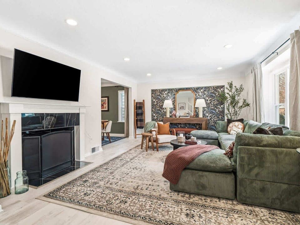 Bright living room w/ comfy seating, layered textures & art-filled walls—perfect for relaxing after a full day out 🛋️✨🎨