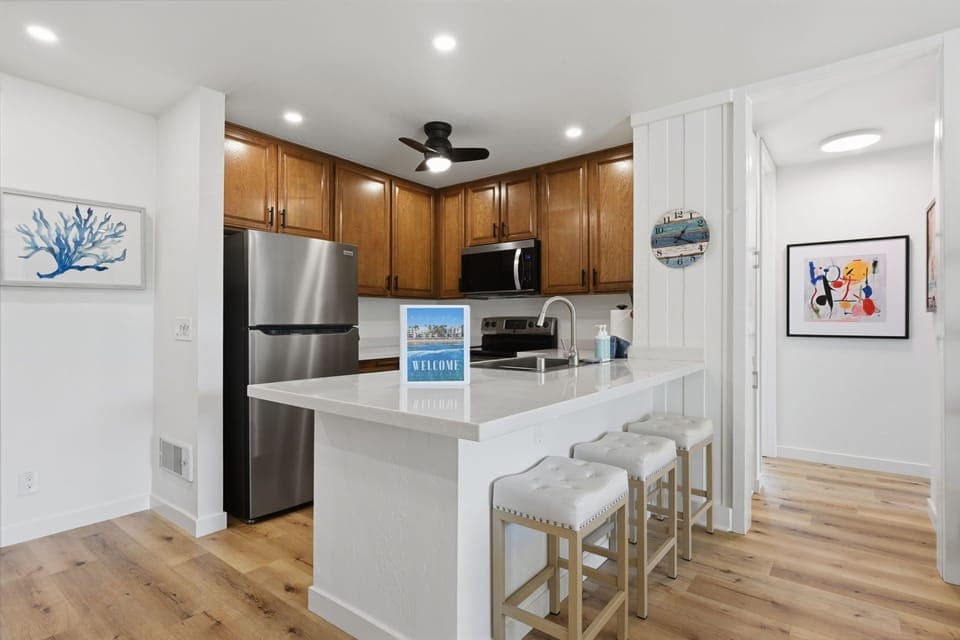 The kitchen island features three additional bar stools for extra seating
