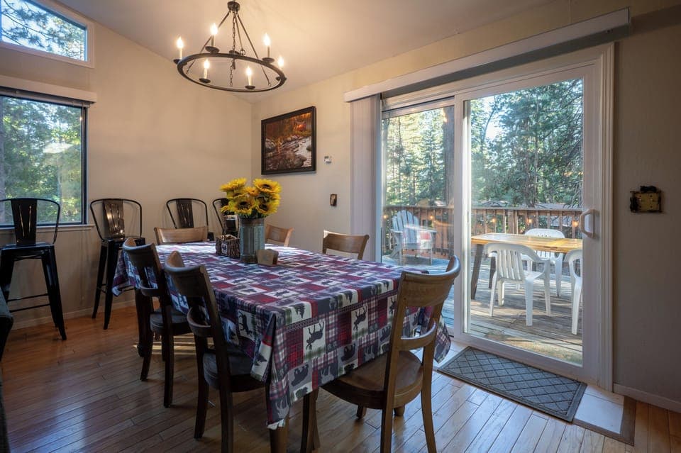 Dining area with access to the deck and peaceful wooded views