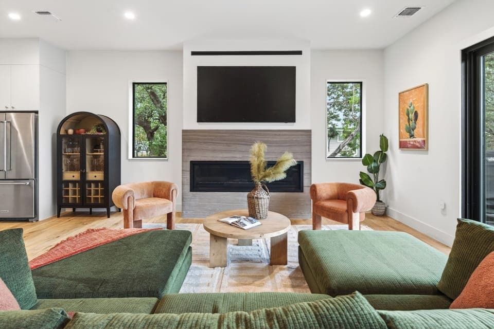 Bright, modern living room with fireplace and comfy seating.