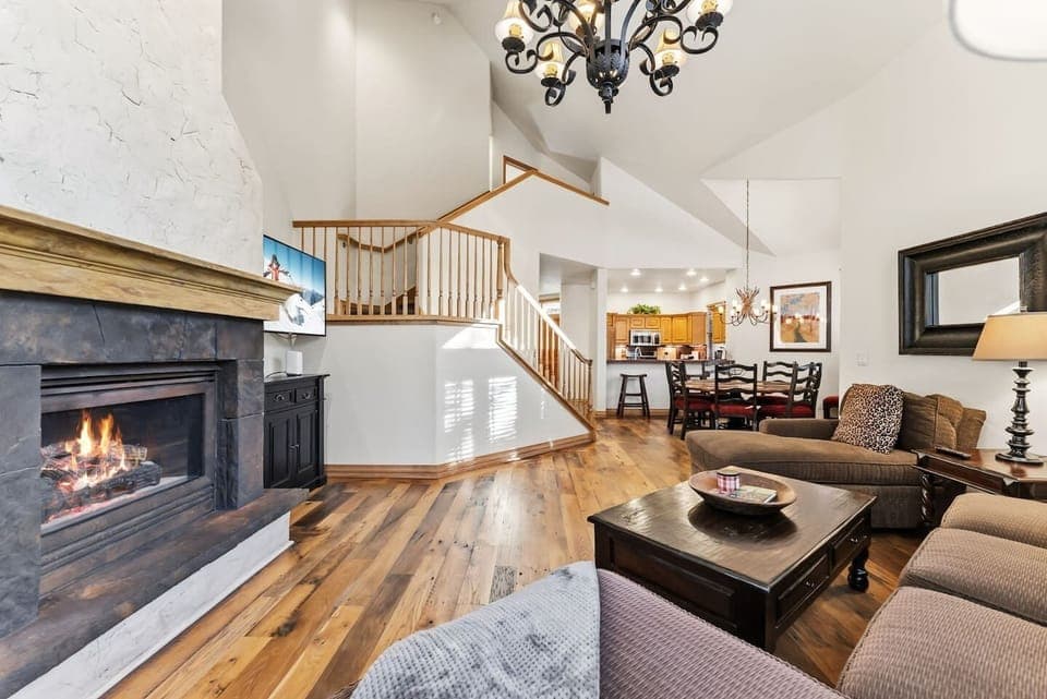 Spacious living room with tons of light, vaulted ceilings, and cozy fireplace