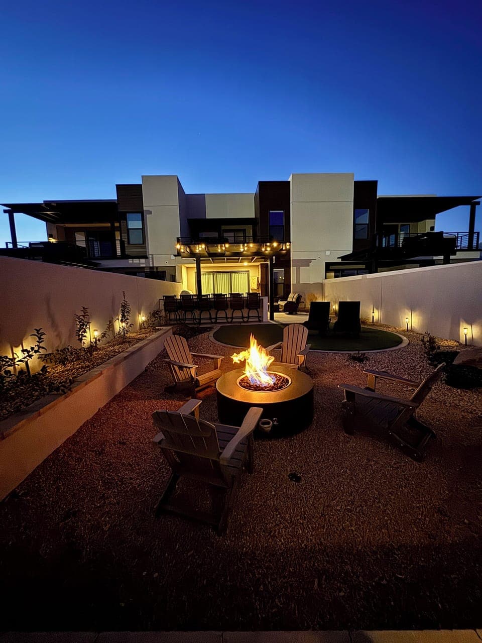 Private back yard at night. Fire pit area shown.