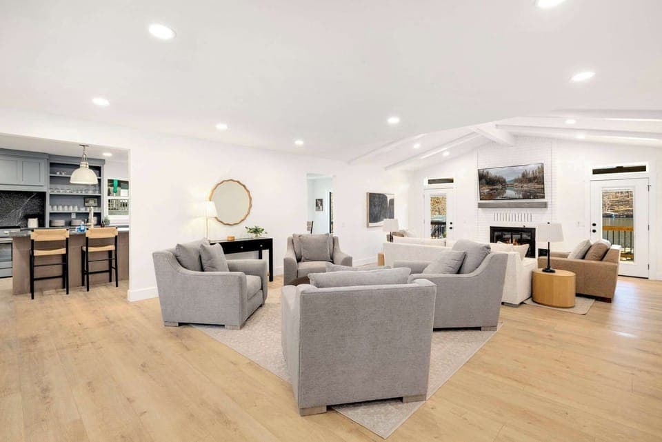 Spacious living room with cozy seating, Smart TV, fireplace, and lake views!