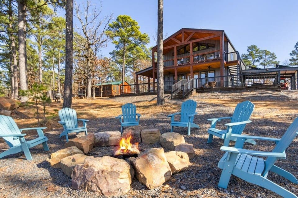 Gather around the massive stone fire pit for s'mores and storytelling, surrounded by towering pines and Adirondack seating.
