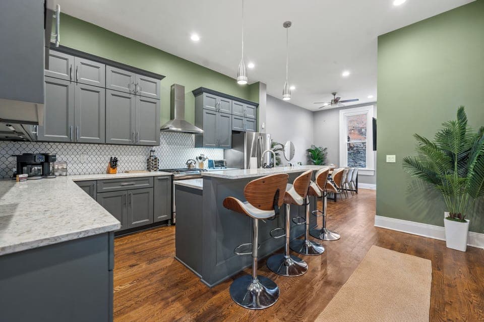 Contemporary, open-concept kitchen. Bright, luxurious space, dining table & TV