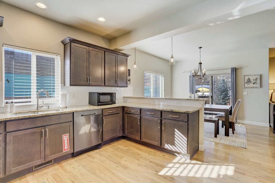 Our fully stocked kitchen offers ample cabinet space and sleek granite surfaces to handle meal prep with ease. It features professional-grade appliances and an intentional layout that flows into the main dining area.