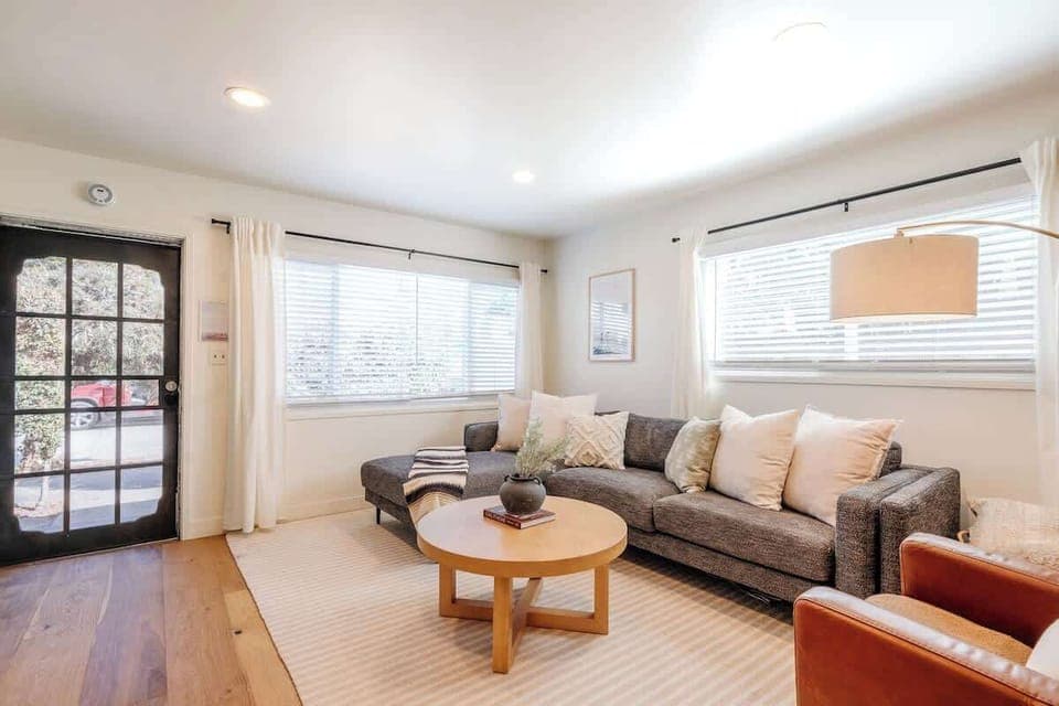 Bright interior design is accented by rays of natural sunlight bursting through the large windows.