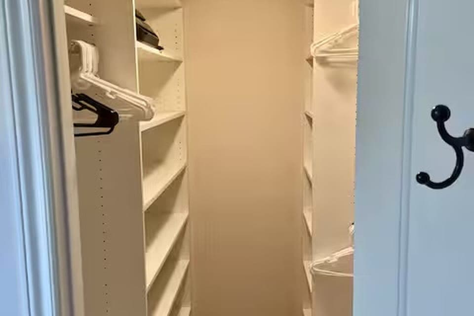 Large walk-in closet with huge drawers in master suite.