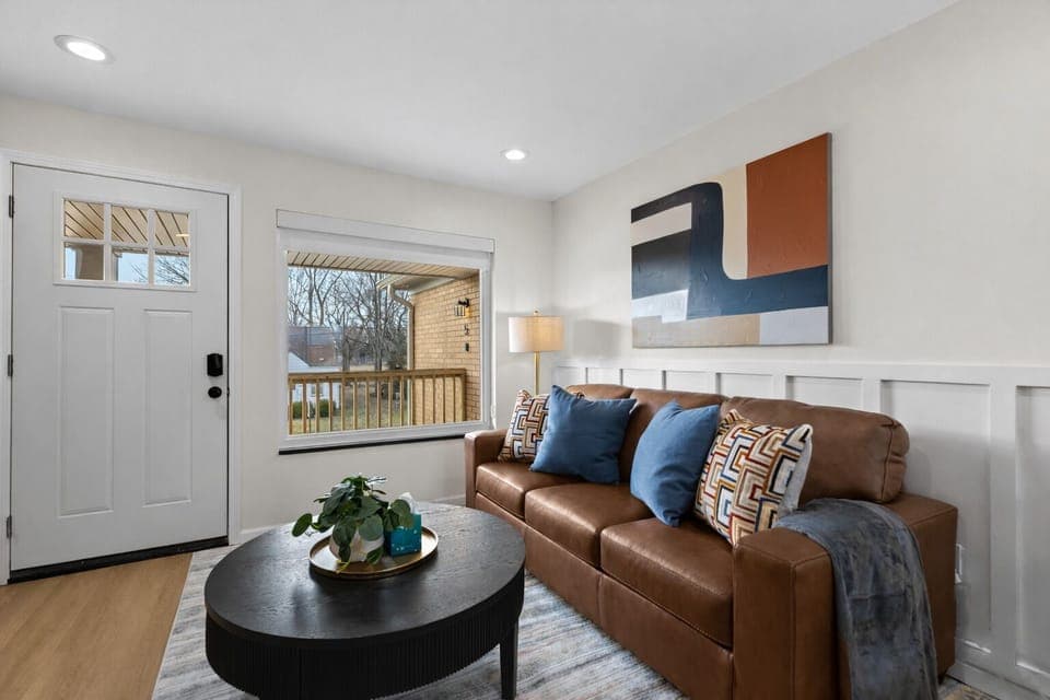 Warm, inviting living room with plush seating, modern décor, and natural light—perfect for relaxing after a day out or enjoying a cozy night in.