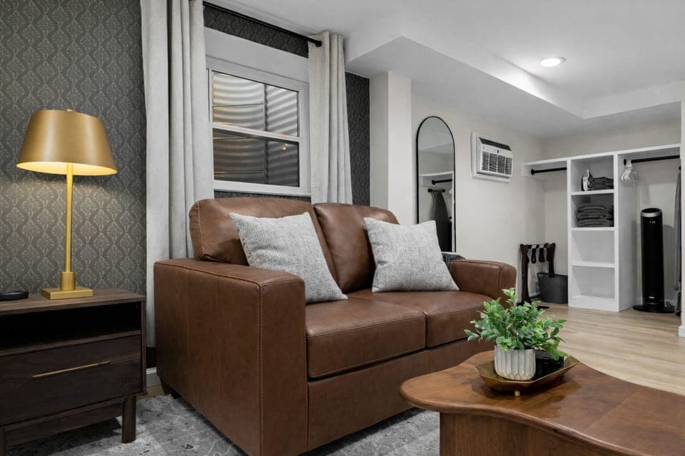 Cozy lounge area with comfortable leather seating, warm accent lighting, and stylish details—an inviting spot to relax, unwind, and feel right at home.
