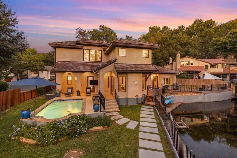 Unwind by the private pool and patio as the sun sets, with warm lighting, lounge seating, and easy access from the living room. A perfect space for relaxing evenings after a day on the lake.