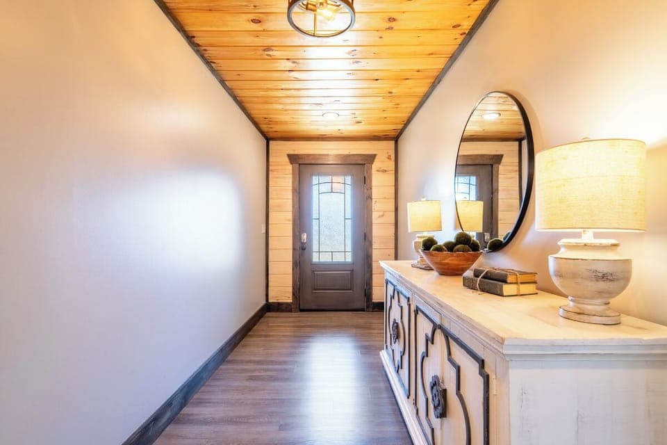 Step into your welcoming entryway where warm wood ceilings and thoughtful décor create an inviting first impression of your home away from home.