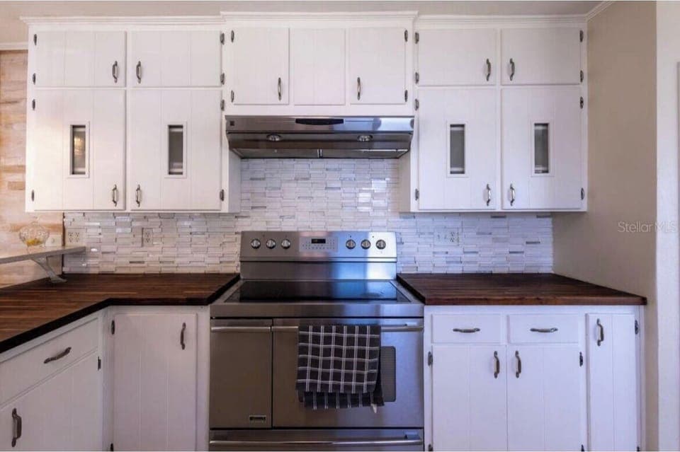 The kitchen is upstairs by the living room, and it is fully stocked!