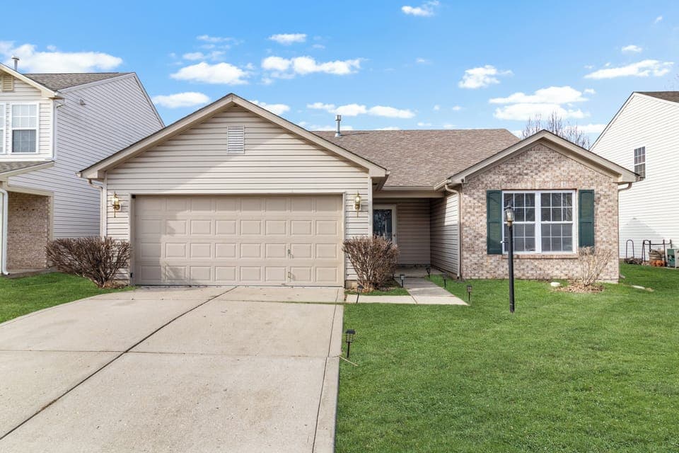 Modern exterior with private driveway and manicured lawn welcoming guests.