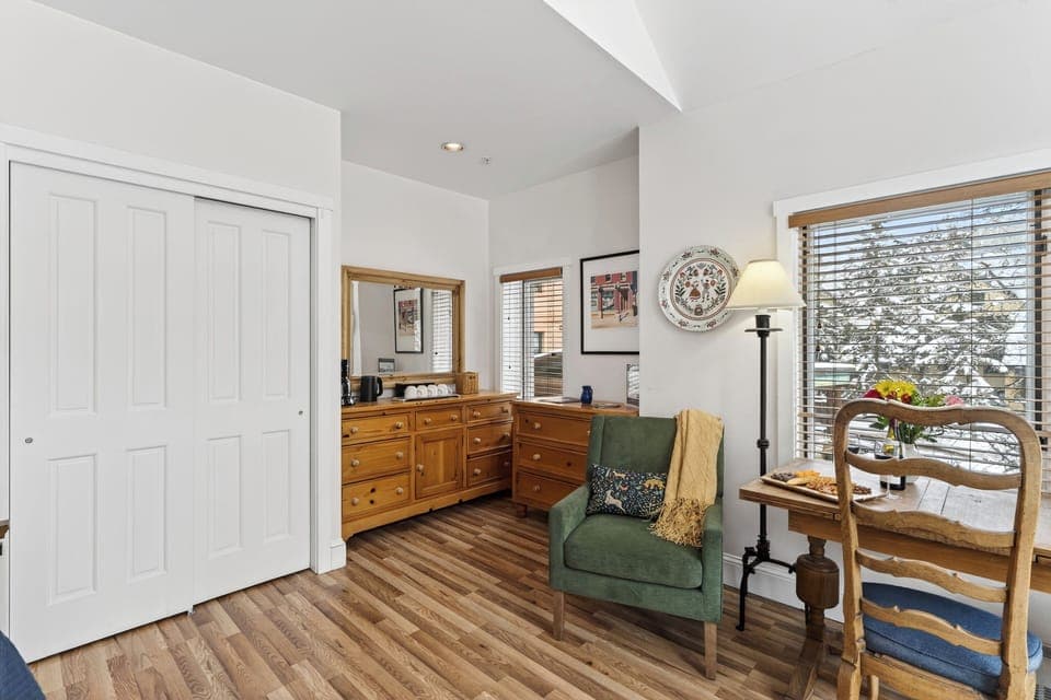 Classic wooden dresser and a comfortable armchair.