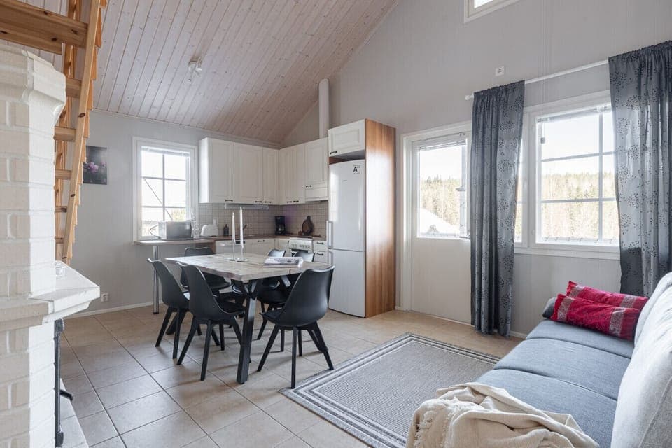 The bright, open-plan layout ensures that the chef in the kitchen stays part of the conversation while everyone relaxes by the large windows.