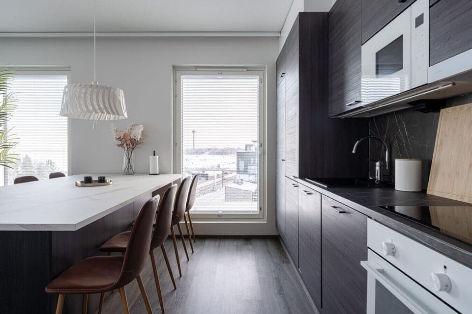 Our sophisticated charcoal kitchen features premium integrated appliances and a stunning stone-effect backsplash, blending style with functionality.