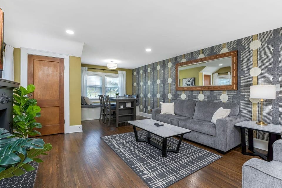 Living room with sleeper sofa, table for 4, smart TV, and window seat