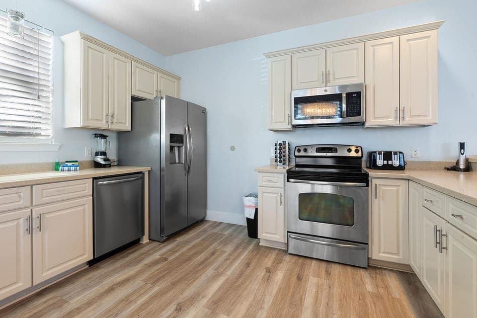 A kitchen that truly works for real stays, with stainless steel appliances, plenty of counter space, and room for more than one person to cook together.