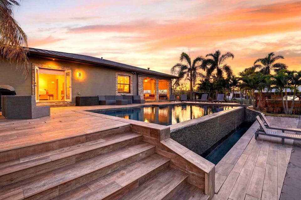 Waterfront living with a private dock, pool and lush tropical surroundings.